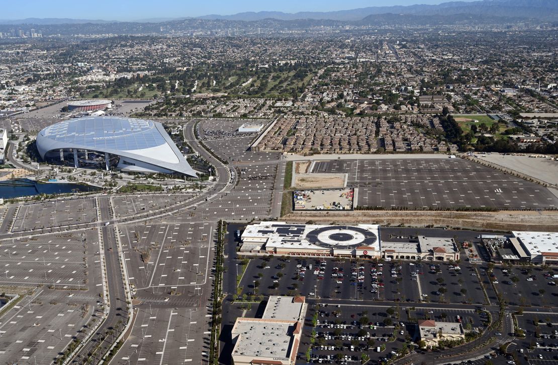 Sofi Stadium in Inglewood, California, surrounded by a shopping mall and housing.