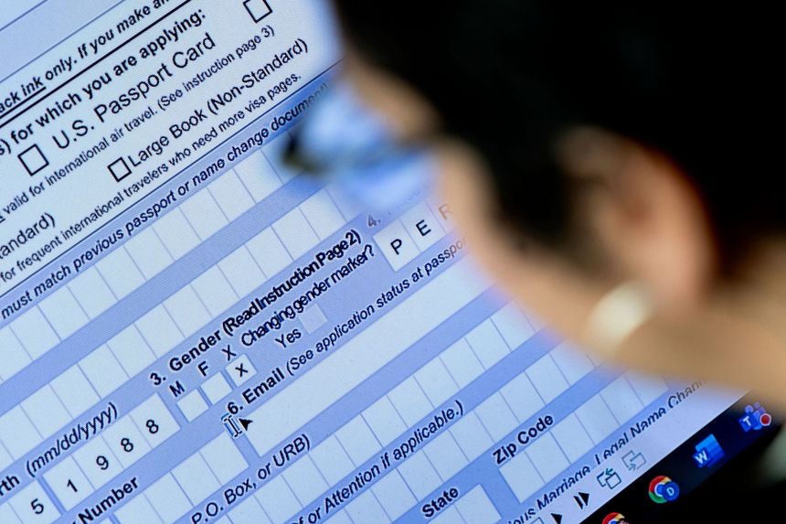 A person begins the process of filling out a passport application with an X gender marker, in April 2022.