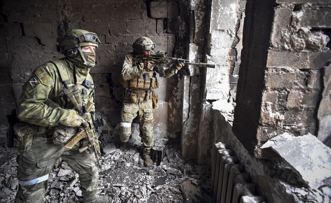 Russian soldiers patrol Mariupol's drama theater, southeastern Ukraine, in March 2022.