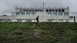 A man walks past the Foxconn headquarters in Tucheng district, New Taipei City on May 6, 2022. (Photo by Sam Yeh / AFP) (Photo by SAM YEH/AFP via Getty Images)