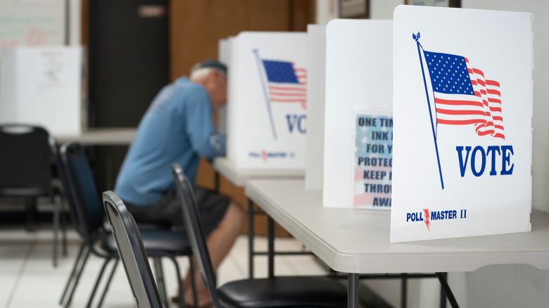 A man fills out a ballot at a voting booth in Mt. Gilead, North Carolina, on on May 17, 2022.