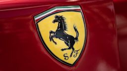 The logo of Italian manufacturer of luxury sports cars Ferrari is pictured on a car in Modena, Northern Italy, during the Motor Valley Fest, the fair of luxury and sport brands of cars and motorbikes factories based in the Emilia-Romagna region, on May 27, 2022. If Tuscany has Chianti, the Italian region of Emilia-Romagna has "Motor Valley", an area that boasts one of the highest concentrations of luxury sports cars and motorbikes in the world. The so-called Land of Motors, covering around 1,000 square kilometres of prime agricultural land roughly between Bologna and Modena, is home to Lamborghini and Ferrari, Maserati and Ducati, in addition to less well-known brands. (Photo by MARCO BERTORELLO / AFP) (Photo by MARCO BERTORELLO/AFP via Getty Images)