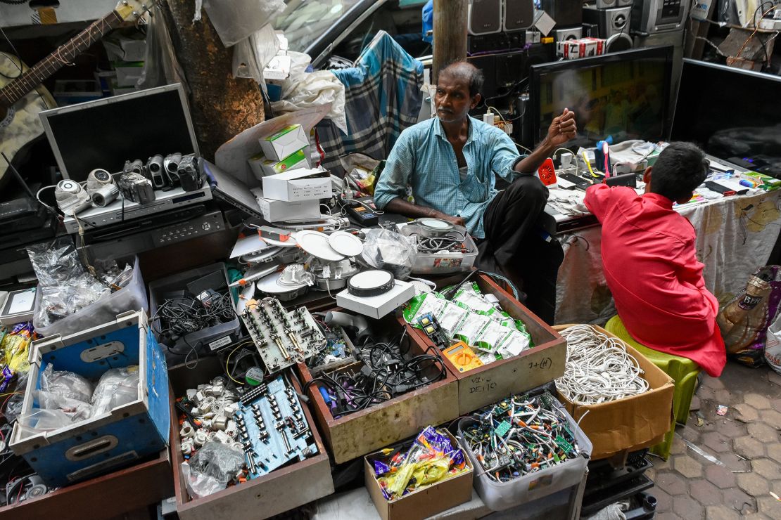A man selling electronic goods at a e-waste market place in Kolkata, India, in June 2022.