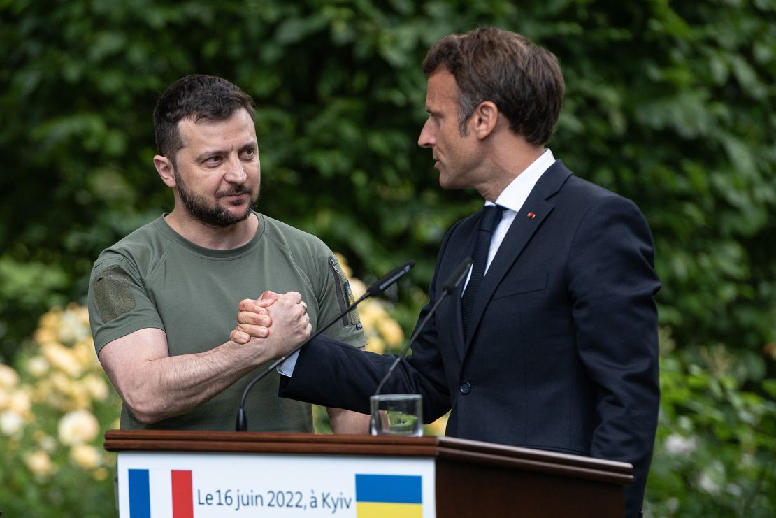 Ukrainian President Volodymyr Zelensky, left, and France's Emmanuel Macron shake hands after a press conference on June 16, 2022 in Kyiv, Ukraine.
