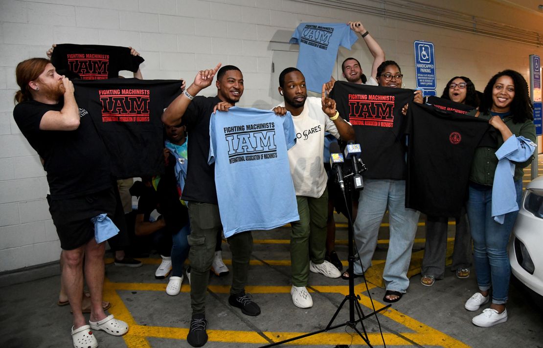 Workers at the Towson Town Center Apple hold their new union T-shirts after their store employees decided to join the International Association of Machinists Union. Theirs is the first Apple store in the US to vote for union representation. (Barbara Haddock Taylor/The Baltimore Sun/Tribune News Service via Getty Images)