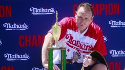 Joey Chestnut sits with the trophy and belt after he won first place, eating 63 hot dogs in 10 minutes, during the 2022 Nathan's Famous Fourth of July International Hot Dog Eating Contest on July 4, 2022 at Coney Island in the Brooklyn borough of New York City.