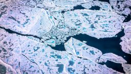 TOPSHOT - An aerial view of pancake ice and melt on July 19, 2022 as captured on a NASA Gulfstream V plane while on an airborne mission with University of Texas scientists to measure melting Arctic seaice. New observations from ICESAT-2 show remarkable Arctic Sea ice thinning in just three years. Over the past two decades, the Arctic has lost about one-third of its winter sea ice volume, largely due to a decline in sea ice that persists over several years, called multiyear ice, according to a new study. The study also found sea ice is likely thinner than previous estimates. (Photo by Kerem Yücel / AFP) (Photo by KEREM YUCEL/AFP via Getty Images)