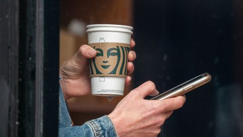 A customer holds a drink inside a Starbucks coffee shop in San Francisco, California, on Thursday, July 28, 2022.