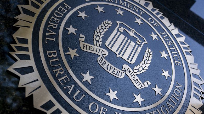 A seal reading "Department of Justice Federal Bureau of Investigation" is displayed on the J. Edgar Hoover FBI building in Washington, DC, o August 9, 2022. (Photo by Stefani Reynolds / AFP) (Photo by STEFANI REYNOLDS/AFP via Getty Images)