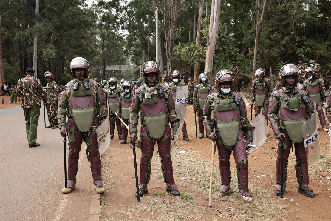 Kenyan police officers wearing riot gear stand on the side of the road near Bomas in Nairobi in August 2022, while waiting for the results of the country's general election.