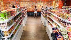 A woman walks past stacks of Instant noodles at the Good Noodle store selling a wide variety of instant noodles from across Asia, in Bangkok on August 25, 2022. - Thailand will raise the price of Thai instant noodles, the trade department said August 24, marking the first price increase on the must-have daily staple in 14 years. - TO GO WITH THAILAND-ECONOMY-INFLATION-NOODLES (Photo by Manan VATSYAYANA / AFP) / TO GO WITH THAILAND-ECONOMY-INFLATION-NOODLES (Photo by MANAN VATSYAYANA/AFP via Getty Images)