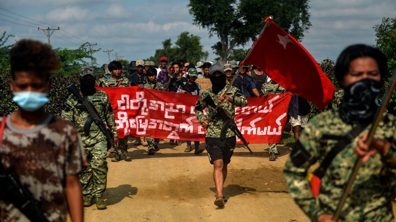 Anti-coup fighters escort protesters as they take part in a demonstration against the military coup in Sagaing, in the Sagaing Division of Myanmar on September 7, 2022.