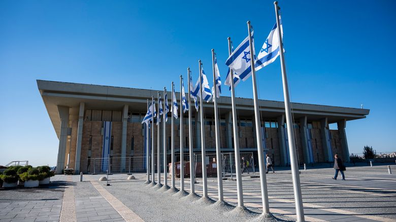 Israeli flags fly in front of the Knesset, the country's parliament.