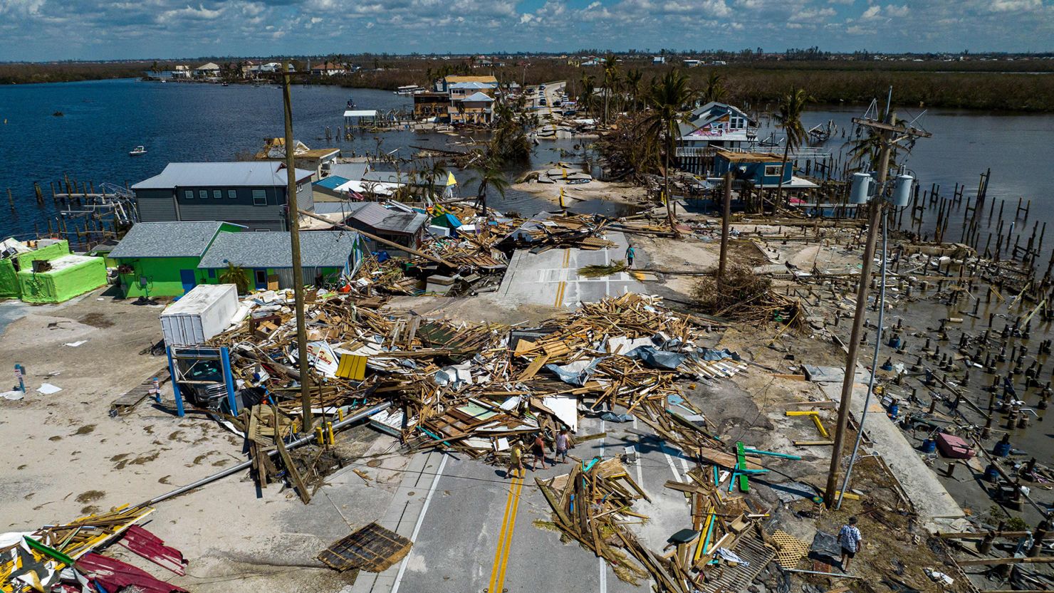 An aerial picture taken on October 1, 2022, shows a broken section of the Pine Island Road, debris and destroyed houses in the aftermath of Hurricane Ian in Matlacha, Florida.