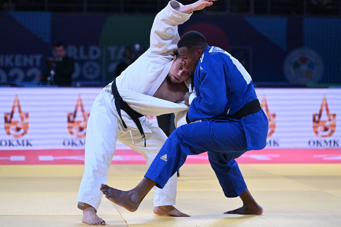 Adnan Khankan (white) competes in their men's under 100 kg category elimination round bout during the 2022 World Judo Championships at the Humo Arena in Tashkent on October 11, 2022.