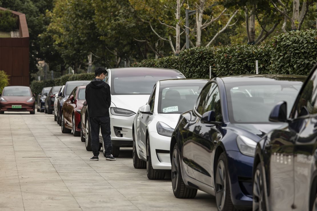 Tesla's electric vehicles lined up outside a showroom in Shanghai, China, in October 2022