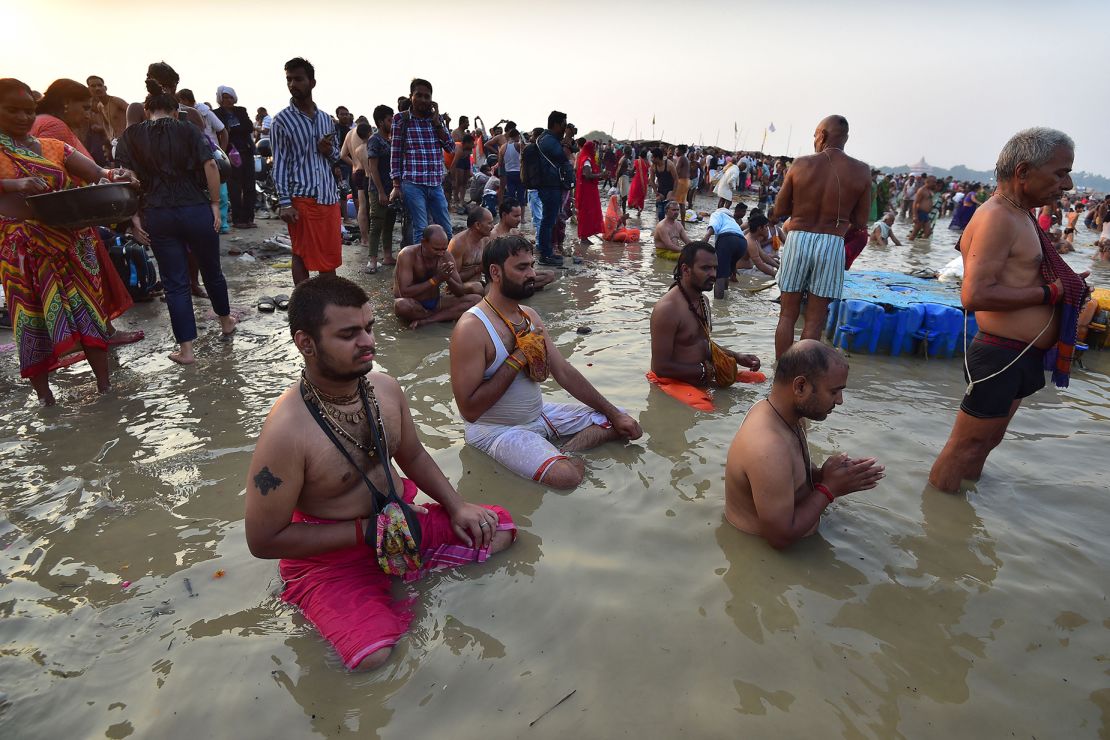 Hindus in Prayagraj pray to the sun god while taking a dip at the Triveni Sangam, the confluence of the Ganges, Yamuna and mythical Saraswati River, during the October 2022 partial solar eclipse.