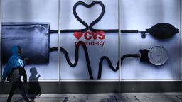 A woman walks past a CVS Pharmacy in Washington, DC, on November 2, 2022.