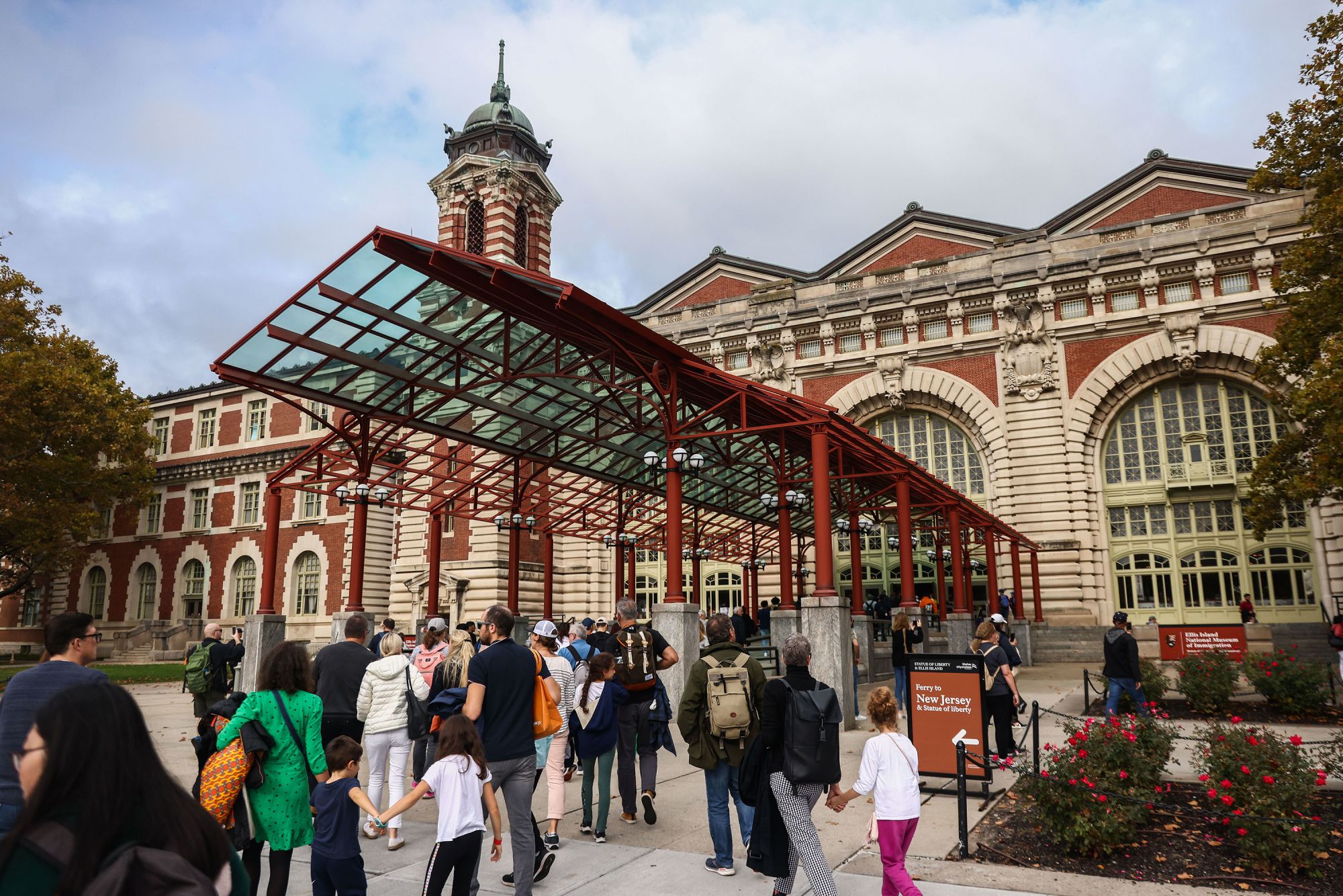 Visitors head into the Ellis Island National Museum of Immigration on October 25, 2022.