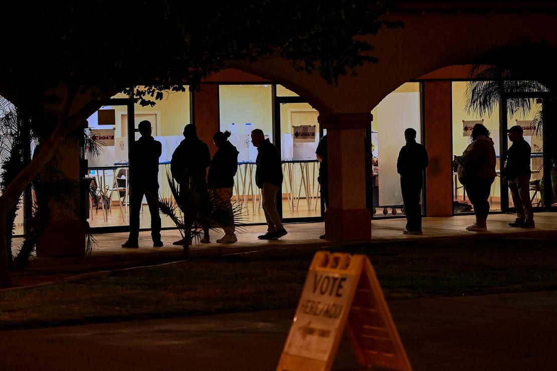 Voters wait in line at a polling station at the Guadalupe Mercado shopping mall in Guadalupe, Arizona, on November 8, 2022.