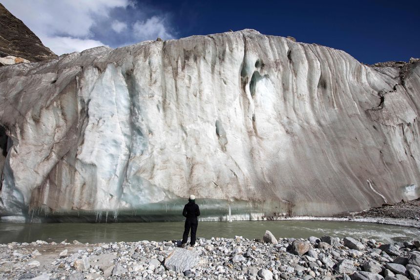 This picture taken in October 2022, shows a trekker observing the Gangotri glacier, which is believed to be the source of the Ganges River.