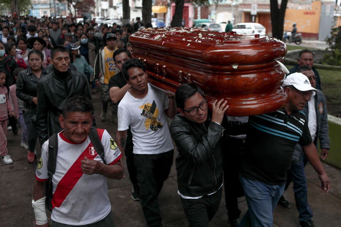 Citizens walk through the streets before burying 34-year-old Jhon Mendoza, who was killed during protests sparked by the ousting of former President Pedro Castillo, in Ayacucho, Peru on December 17, 2022.