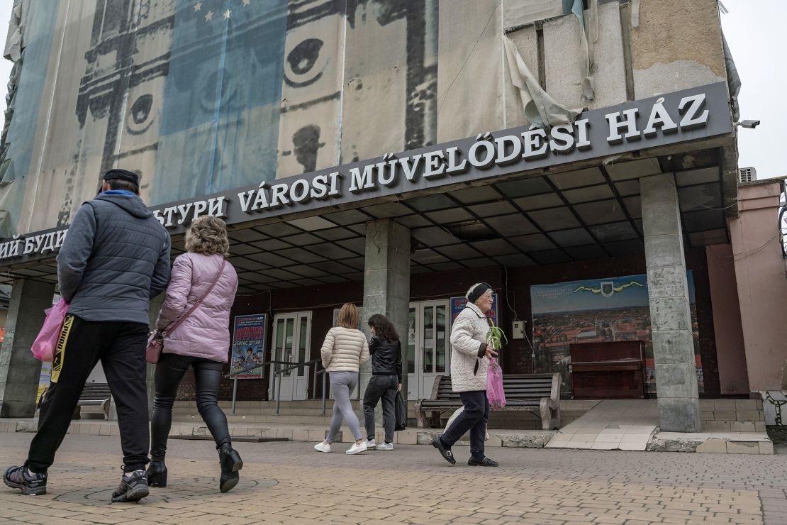People walk past Hungarian and Ukrainian signs in the western Ukrainian city of Berehove in November 2022.
