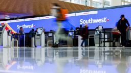 Travelers walk past the Southwest Airlines check-in counter at Denver International Airport on December 28, 2022 in Denver, Colorado.