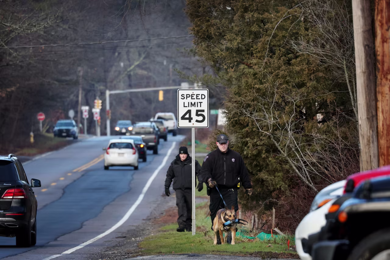 Members of a Massachusetts State Police K-9 unit search for Ana Walshe on January 7, 2023, in Cohasset, Massachusetts.