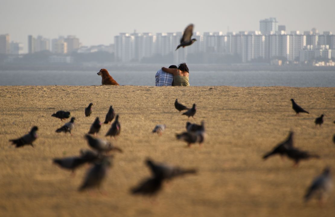 A couple on a beach in Mumbai, India, on February 21, 2023.