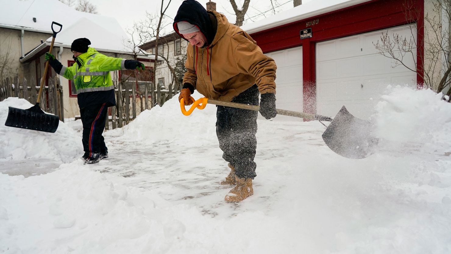 Snow shovelers during a snowstorm in Minneapolis, Minnesota, on February 22, 2023, during a snow-filled winter. Winter has done a 180 in the city year-over-year and now the city has less snow than Nashville.