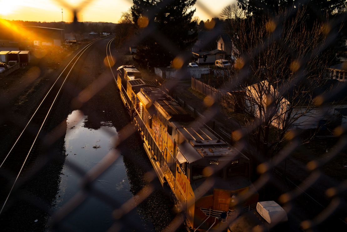 A Norfolk Southern train passes underneath a bridge on February 25, 2023 in East Palestine, Ohio. On February 3rd, a Norfolk Southern Railways train carrying toxic chemicals derailed causing an environmental disaster.