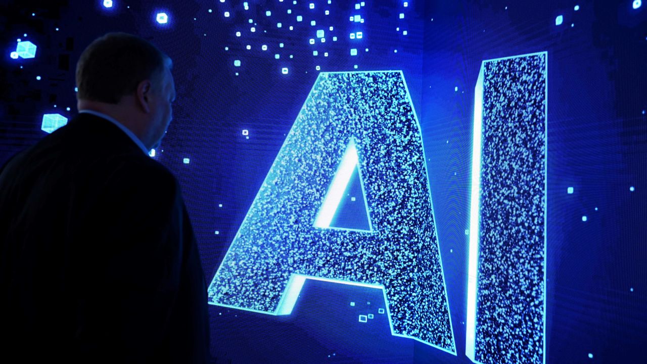 A visitor watches an AI (Artificial Intelligence) sign on an animated screen at the Mobile World Congress (MWC), the telecom industry's biggest annual gathering, in Barcelona. (Photo by Josep LAGO / AFP) (Photo by JOSEP LAGO/AFP via Getty Images)