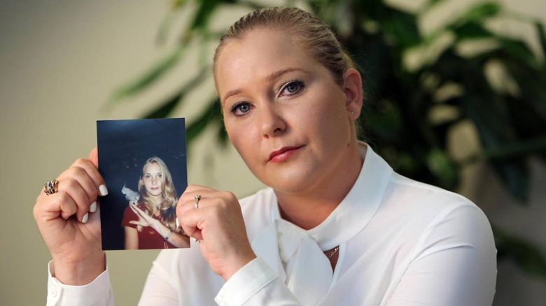 Virginia Giuffre holds a photo of herself as a teen.
