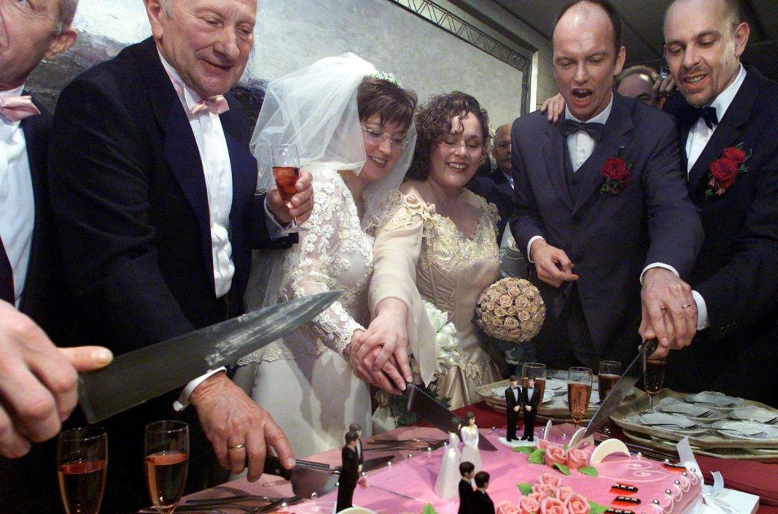 Gay couples cut a wedding cake in Amsterdam on April 1, 2001 after the first same-sex marriage law was passed in the Netherlands.