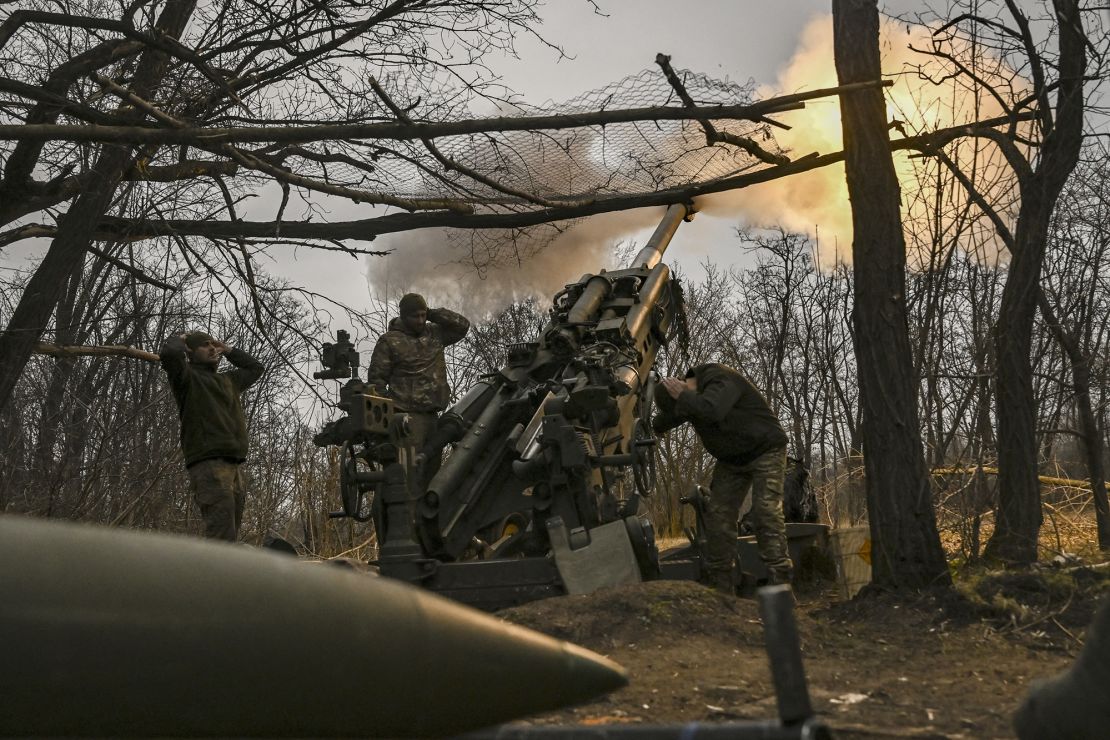 Ukrainian servicemen fire a M777 howitzer at Russian positions near Bakhmut, eastern Ukraine, on March 17, 2023.