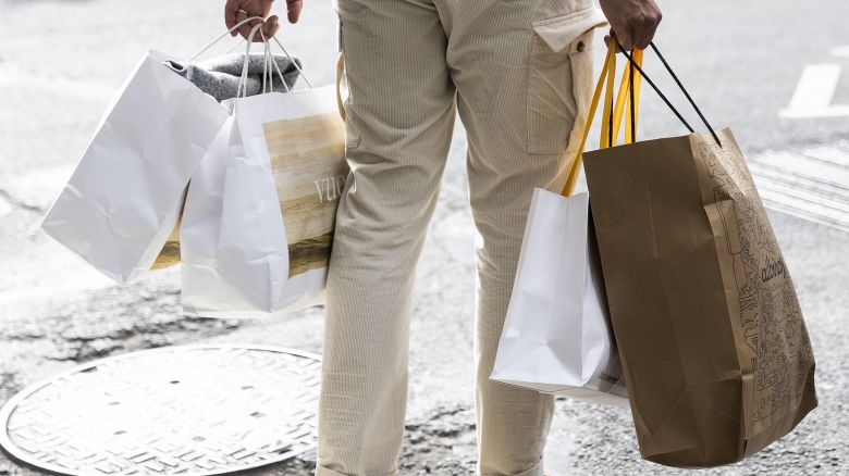 A pedestrian carries shopping bags in the SoHo neighborhood of New York, US on Wednesday, March 22, 2023.