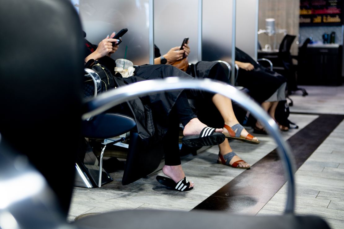 Women sit at the sinks at Tapestry Salon & Spa in West Babylon, New York in June 2020.