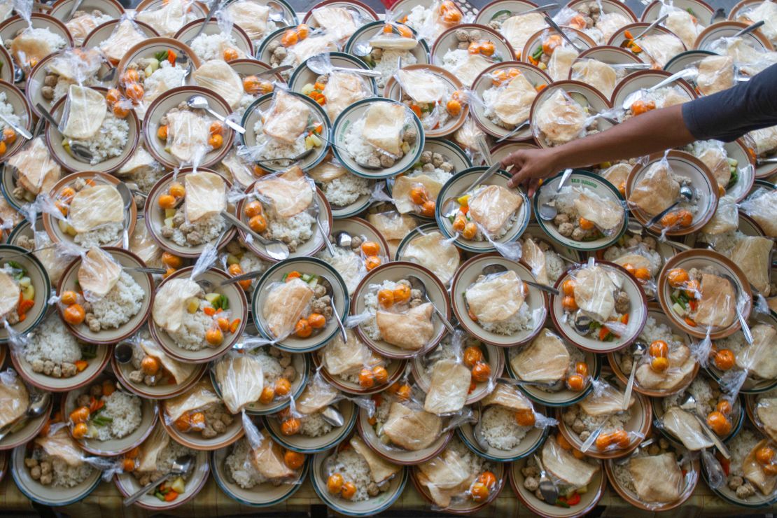 A Muslim person prepares meals for breaking fast during Ramadan at a mosque in Yogyakarta on the island of Java in Indonesia, on March 28, 2023.