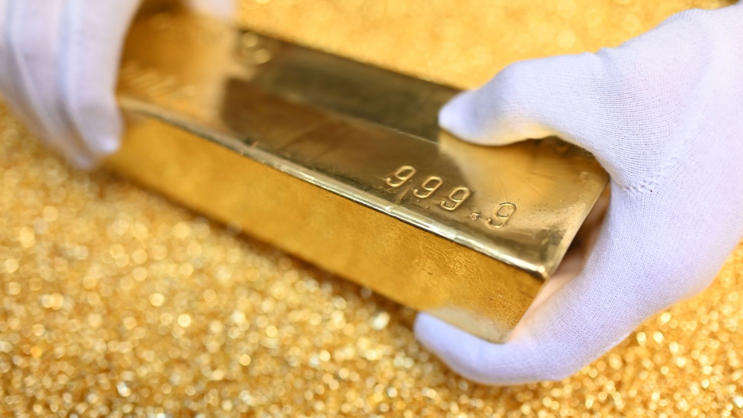 At Agosi AG in Pforzheim, Germany, a gold bar with a fine gold content of 99.99 percent and resting on gold granules is on display.