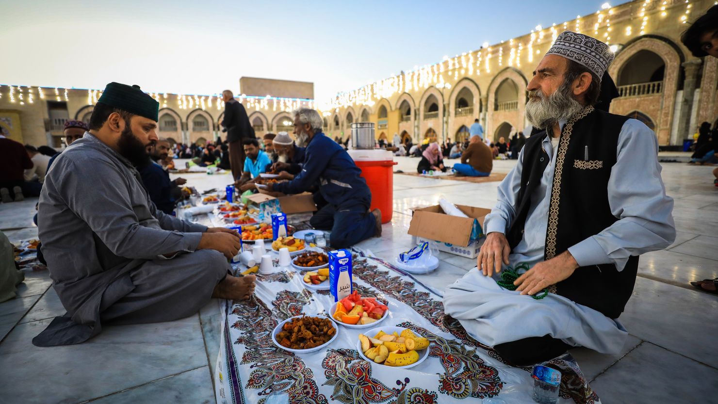 Muslims have iftar, the fast-breaking evening meal, during the Islamic holy month of Ramadan at Abdul-Qadir Gilani Complex on March 30, 2023 in Baghdad, Iraq.