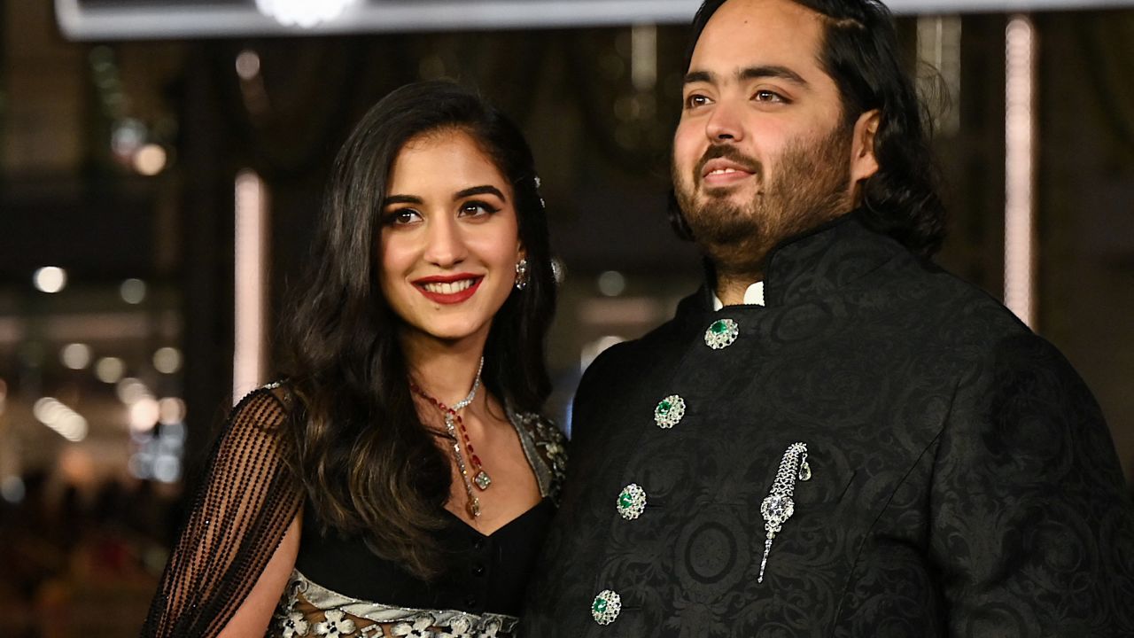 In this picture taken on March 31, 2023, Anant Ambani (R), son of Indian businessman Mukesh Dhirubhai Amani, and his wife Radhika Merchant pose for pictures during the inauguration of the Nita Mukesh Ambani Cultural Centre (NMACC) at the Jio World Centre (JWC) in Mumbai. (Photo by SUJIT JAISWAL / AFP) (Photo by SUJIT JAISWAL/AFP via Getty Images)