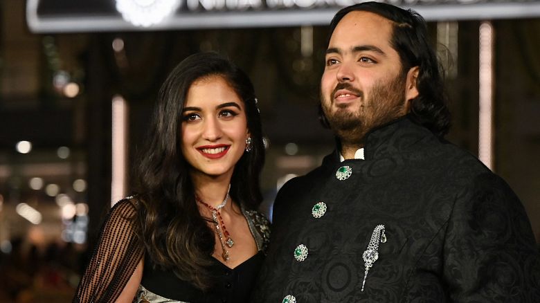 In this picture taken on March 31, 2023, Anant Ambani (R), son of Indian businessman Mukesh Dhirubhai Amani, and his wife Radhika Merchant pose for pictures during the inauguration of the Nita Mukesh Ambani Cultural Centre (NMACC) at the Jio World Centre (JWC) in Mumbai. (Photo by SUJIT JAISWAL / AFP) (Photo by SUJIT JAISWAL/AFP via Getty Images)
