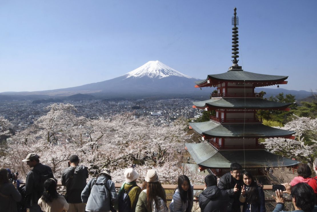 Photo taken on April 3, 2023, shows a popular scenic spot where Mt. Fuji, a red five-story pagoda and cherry blossoms in full bloom can be seen all together at Asakurayama Sengen Park in Fujiyoshida, Yamanashi Prefecture in eastern Japan. (Photo by Kyodo News via Getty Images)