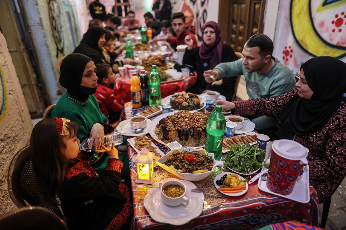 Palestinians gather for iftar at tables set up in the streets of Khan Younis in Gaza, on April 4, 2023.