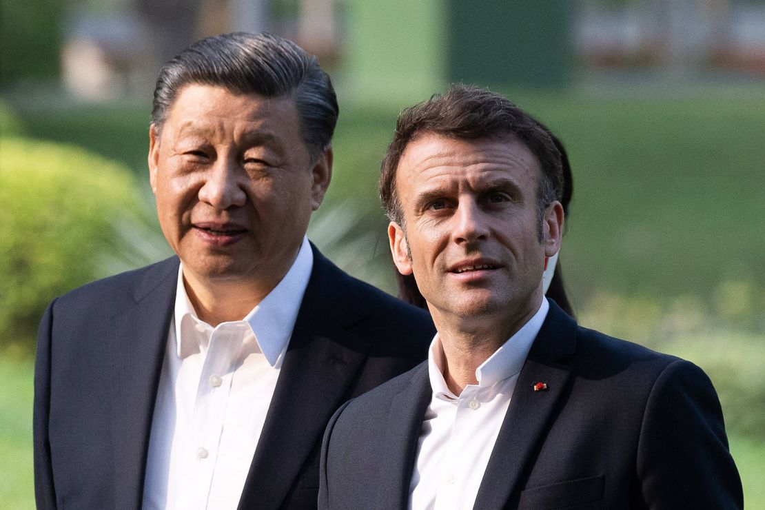 Chinese leader Xi Jinping and French President Emmanuel Macron visit a garden in Guangdong during Macron's state visit to China last April.