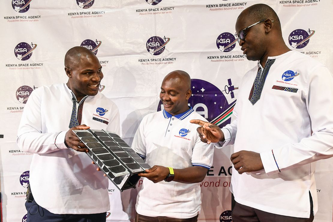 Kenya deployed its first Earth observation satellite, Taifa-1, into space in April 2023. It was developed and designed by Kenyans, but manufactured in Bulgaria. Here, Kenya Space Agency (KSA) engineers Aloyce Were (L), Deche Bungule (C) and Andrew Nyawade hold the prototype of Taifa-1 satellite at the University of Nairobi in April 2023.