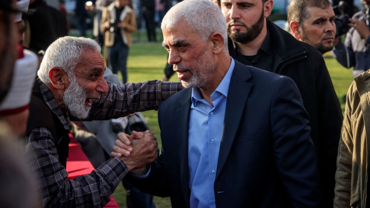 Yahya al-Sinwar (R), Gaza Strip chief of the Palestinian Islamist Hamas movement, greets a  supporter as he arrives to attend a rally marking Al-Quds (Jerusalem) Day, a commemoration in support of the Palestinian people celebrated annually on the last Friday of the Muslim fasting month of Ramadan, in Gaza City, on April 14, 2023. (Photo by MOHAMMED ABED / AFP) (Photo by MOHAMMED ABED/AFP via Getty Images)