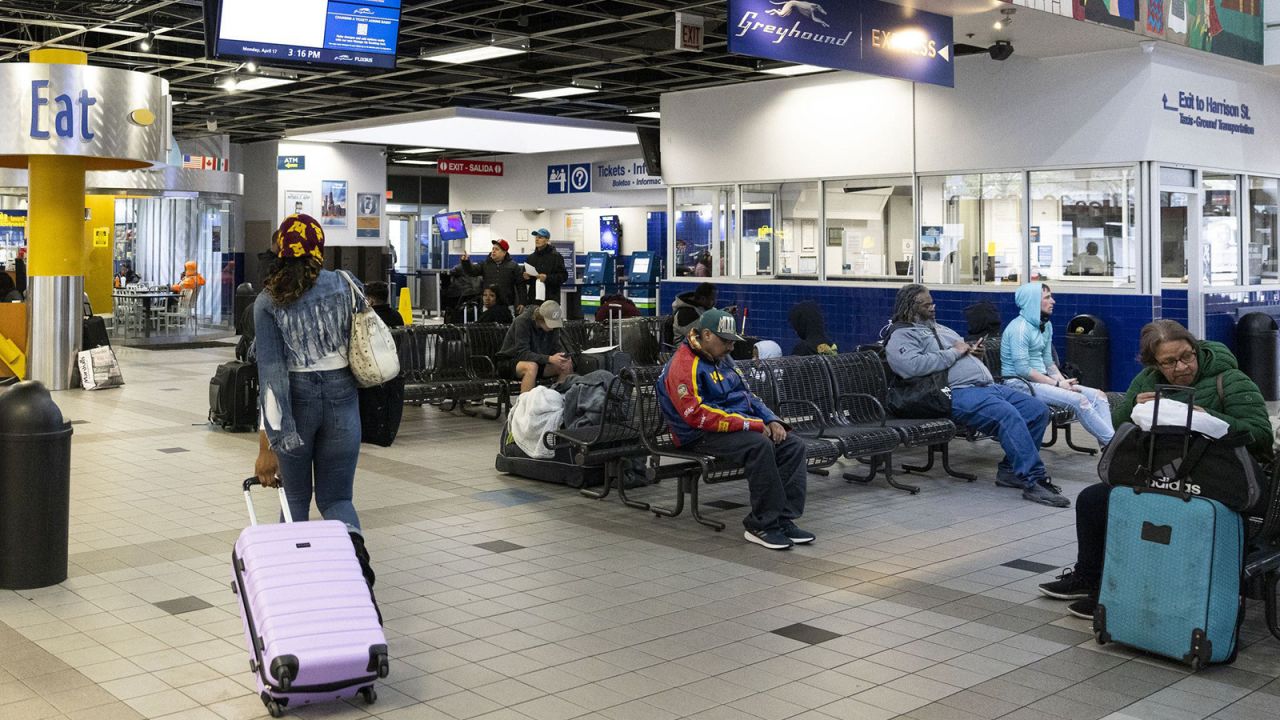 Travelers wait in the Greyhound bus station in the Near West Side neighborhood on April 17, 2023.