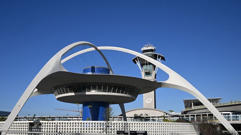 The Theme building, home of the now closed Encounter restaurant, in seen in front of LAX air traffic control tower at Los Angeles International Airport in Los Angeles on April 20, 2023. (Photo by Robyn BECK / AFP) (Photo by ROBYN BECK/AFP via Getty Images)